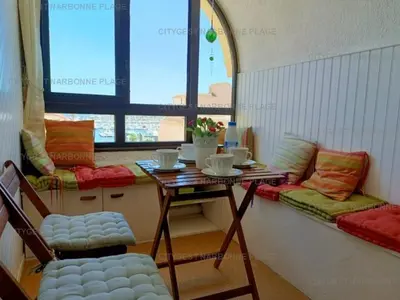 a room with a table and chairs and a window at Appartement charmant avec balcon, piscine - 5 pers. - FR-1-619-159 in Gruissan