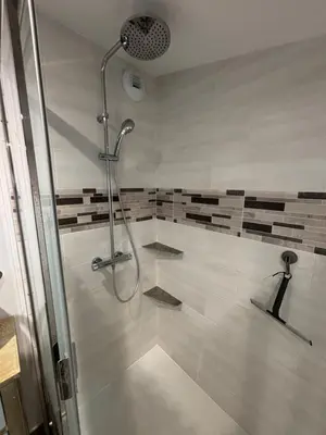 a shower stall in a bathroom with a shower at Clos des pins- Climatisation-Parking-Draps By LCG in Gruissan