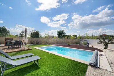 a jacuzzi tub in a backyard at night at Villa Avec Piscine Spa Et Sauna in Saint-Nazaire-dʼAude