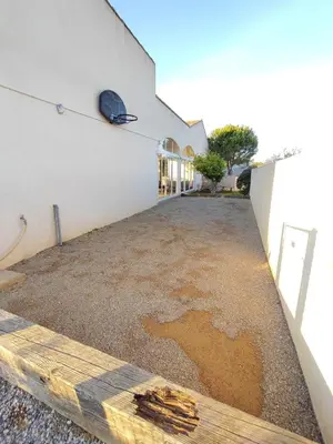 a driveway of a building with a puddle of water at Hacienda Del Sol, beautiful villa with pool in Sigean