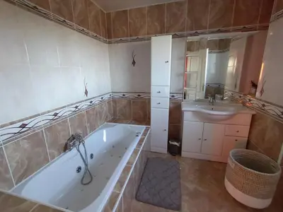 a large bathroom with a tub and a sink at Hacienda Del Sol, beautiful villa with pool in Sigean