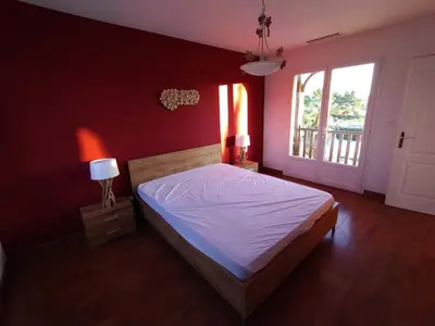 a bedroom with a large bed and a window at Hacienda Del Sol, beautiful villa with pool in Sigean