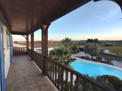 a balcony of a house with a swimming pool at Hacienda Del Sol, beautiful villa with pool in Sigean