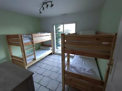 a room with two bunk beds and a window at Hacienda Del Sol, beautiful villa with pool in Sigean