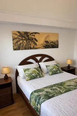 a bedroom with a bed and two night stands with lamps at Charmant appartement proche du port in Gruissan