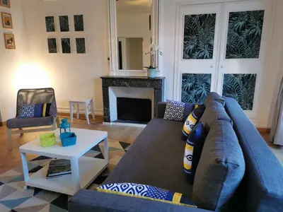 a living room with a couch and a fireplace at Aviator in Carcassonne