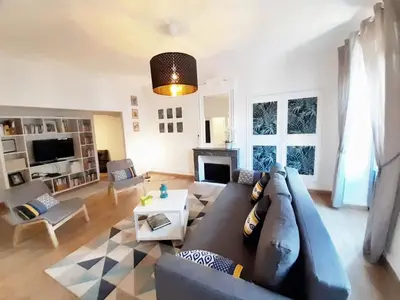 a living room with a couch and a table at Aviator in Carcassonne