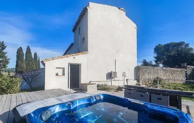 a bath tub in front of a building at Maison Avec Piscine Et Jacuzzi in Rieux-Minervois