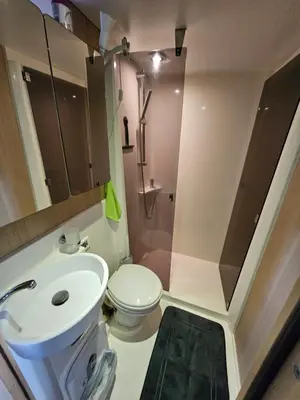 a bathroom with a toilet and a sink and a shower at NAVYLIS Croisière in Capestang