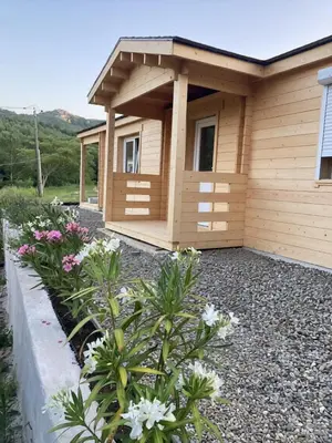 a small building with flowers in front of it at Au pied du plateau in Campagne-sur-Aude
