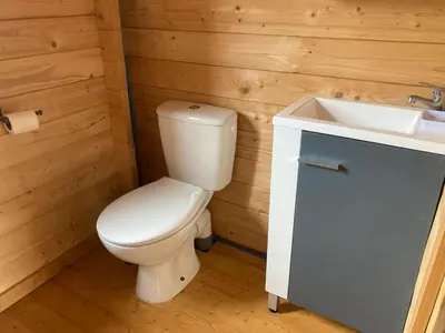 a bathroom with a white toilet and a sink at Au pied du plateau in Campagne-sur-Aude