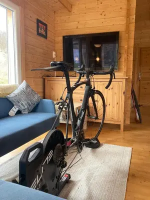 a bike parked in a living room with a tv at Au pied du plateau in Campagne-sur-Aude