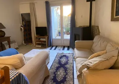 a living room with two couches and a rug at Maison & Village Quarante - French Village House in Quarante