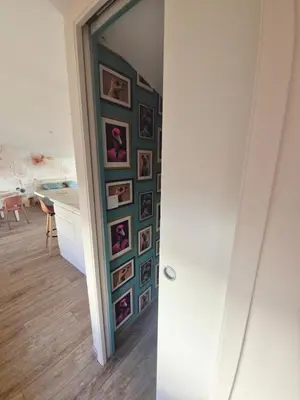 a hallway with a wall with pictures on it at Studio cosy in Burlats