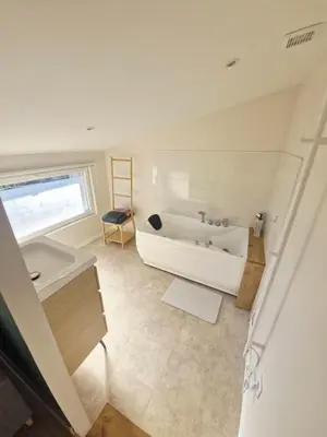 a white bathroom with a tub and a sink at Studio cosy in Burlats
