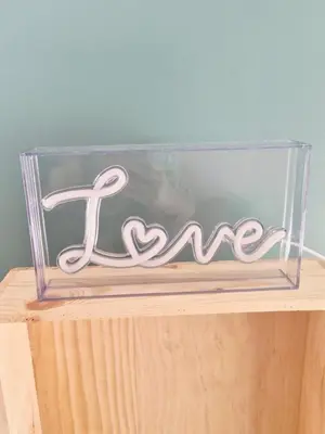 a clear glass box with a sign that says love at Studio cosy in Burlats