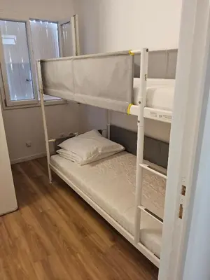 two bunk beds in a room with a wooden floor at Barracuda of port terrace sea for 6 in Port-la-Nouvelle