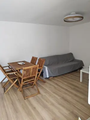 a room with a table and chairs and a bed at Barracuda of port terrace sea for 6 in Port-la-Nouvelle
