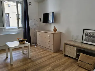 a living room with a dresser and a tv at Barracuda of port terrace sea for 6 in Port-la-Nouvelle