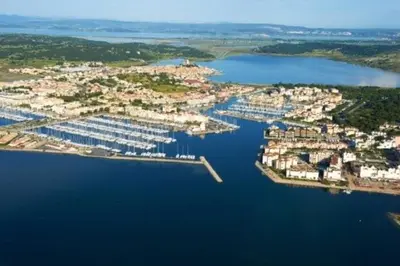 an aerial view of a city with a harbor at Villa de charme avec piscine privée au sel in Gruissan