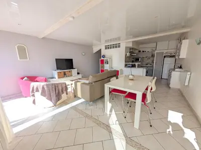 a kitchen and living room with a table and a couch at Appartement climatisé vue mer - 4 pers. - FR-1-797-65 in Port-la-Nouvelle