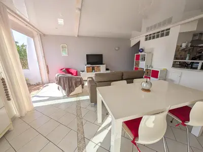a living room with a couch and a table at Appartement climatisé vue mer - 4 pers. - FR-1-797-65 in Port-la-Nouvelle