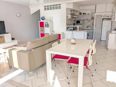 a living room with a white table and a couch at Appartement climatisé vue mer - 4 pers. - FR-1-797-65 in Port-la-Nouvelle