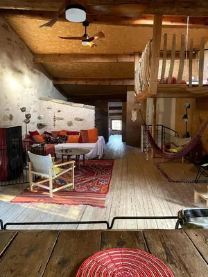 a living room with a couch and a table at Charming house in Tournissan