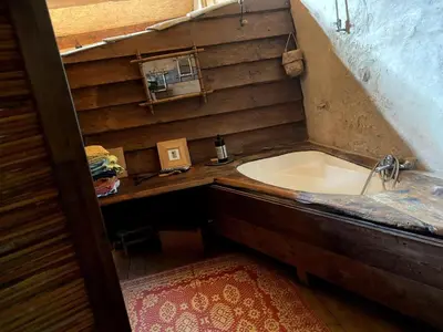a bathroom with a tub and a sink at Charming house in Tournissan