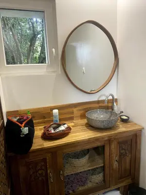 a bathroom with a sink and a mirror at Charming house in Tournissan