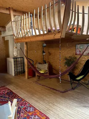 a room with a hammock hanging from a ceiling at Charming house in Tournissan