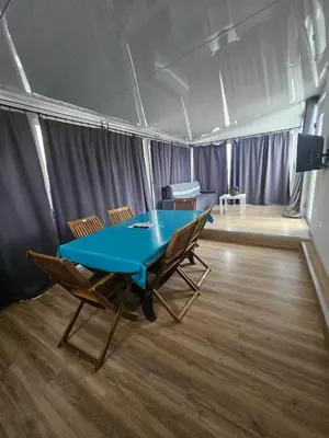 a living room with a table and a couch at Big 8 at Beach Clim Mer Terrace for 6 in Port-la-Nouvelle