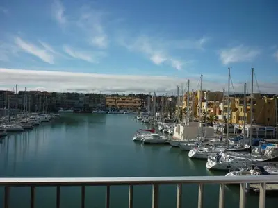 a marina with many boats docked in the water at Studio cabine – 2 couchages – Vue port – Résidence Le Chébeck – Gruissan in Gruissan