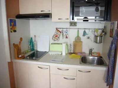 a kitchen with a sink and a counter top at Studio cabine – 2 couchages – Vue port – Résidence Le Chébeck – Gruissan in Gruissan