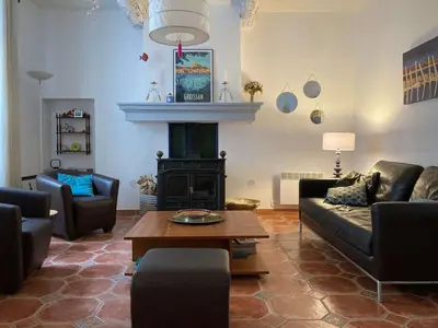 a living room with a couch and a fireplace at AIG 63 – Grande maison de village avec Wi-Fi – Gruissan – 13 personnes in Gruissan