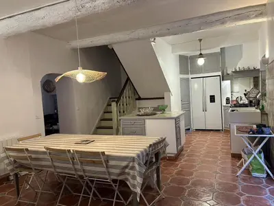 a kitchen and dining room with a table and chairs at AIG 63 – Grande maison de village avec Wi-Fi – Gruissan – 13 personnes in Gruissan