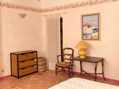a bedroom with a desk and a table and a chair at AIG 63 – Grande maison de village avec Wi-Fi – Gruissan – 13 personnes in Gruissan