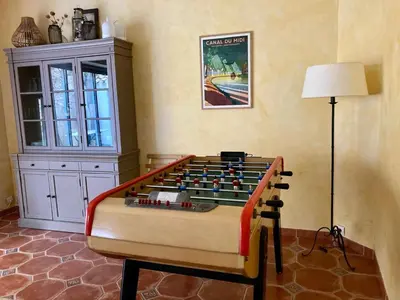 a foosball table in the corner of a room at AIG 63 – Grande maison de village avec Wi-Fi – Gruissan – 13 personnes in Gruissan