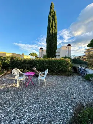 a group of three chairs sitting on top of gravel at Rez de jardin accès direct plage in Gruissan