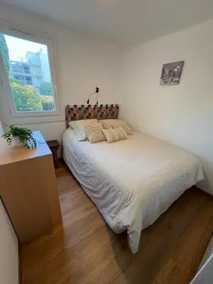 a bedroom with a bed and a window at Rez de jardin accès direct plage in Gruissan