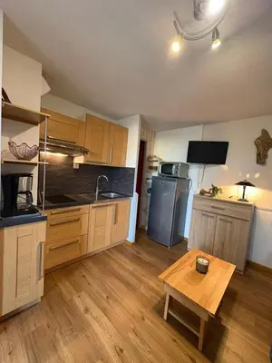 a large kitchen with a table in a room at Rez de jardin accès direct plage in Gruissan