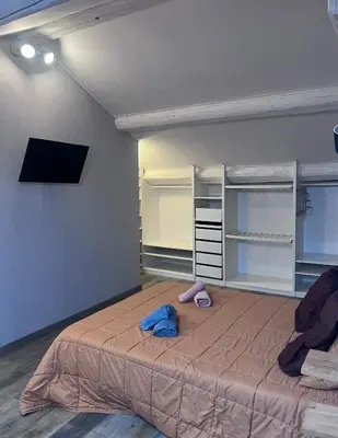 a bedroom with a large bed and a tv at Bel appartement, Deux chambres, Deux salles de bain in Vinassan