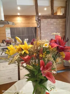 a bouquet of flowers in a vase on a table at La Cave à Julie in Mirepoix