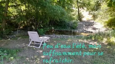 a stream of water in a field with trees at Maison au pied de la Montagne Noire 6 to 13 people in Cassagnolles
