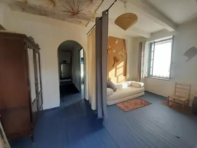 a kitchen and living room with a table and chairs at Maison au pied de la Montagne Noire 6 to 13 people in Cassagnolles