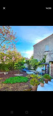 a building with potted plants next to a river at Big Sur Room in Carcassonne