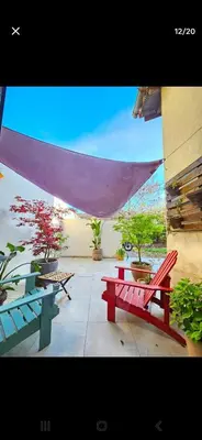 a patio with red benches and potted plants at Big Sur Room in Carcassonne