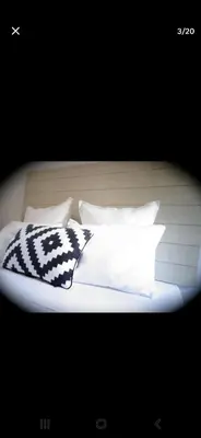 a white bed with four pillows on it at Big Sur Room in Carcassonne