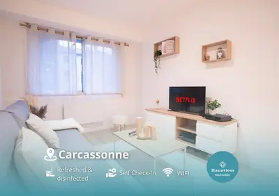 a living room with a glass table and a tv at Centre de Carcassonne 2min gare in Carcassonne