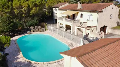 an overhead view of a swimming pool in front of a house at Villa avec piscine, jardin de 8000m2, cuisine extérieur à 20min de Carcassonne in Arzens